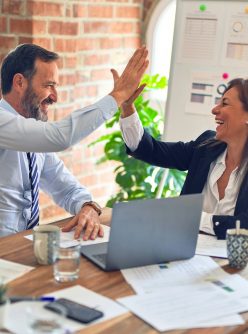 man in white dress shirt sitting beside woman in black long sleeve shirt